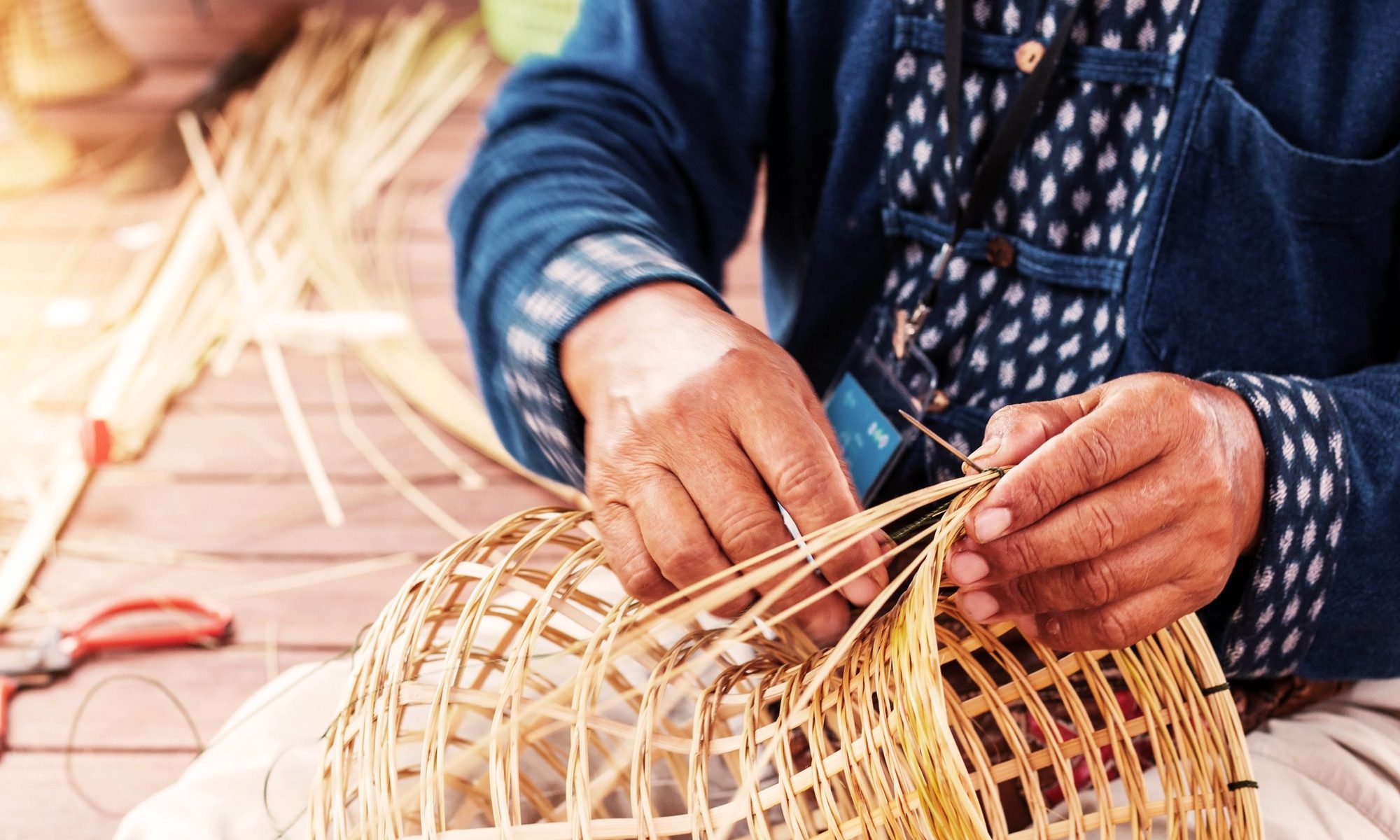Hands weave bamboo baskets